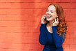© contrastwerkstatt - Laughing woman holding smart phone to her ear