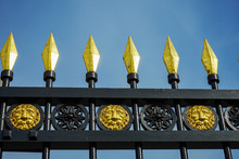 Gold-plated Peaks On An Old Wrought-iron Fence.