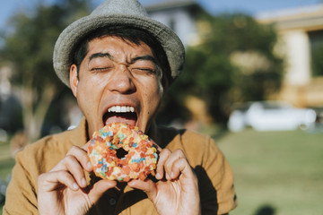 Happy man having a doughnut