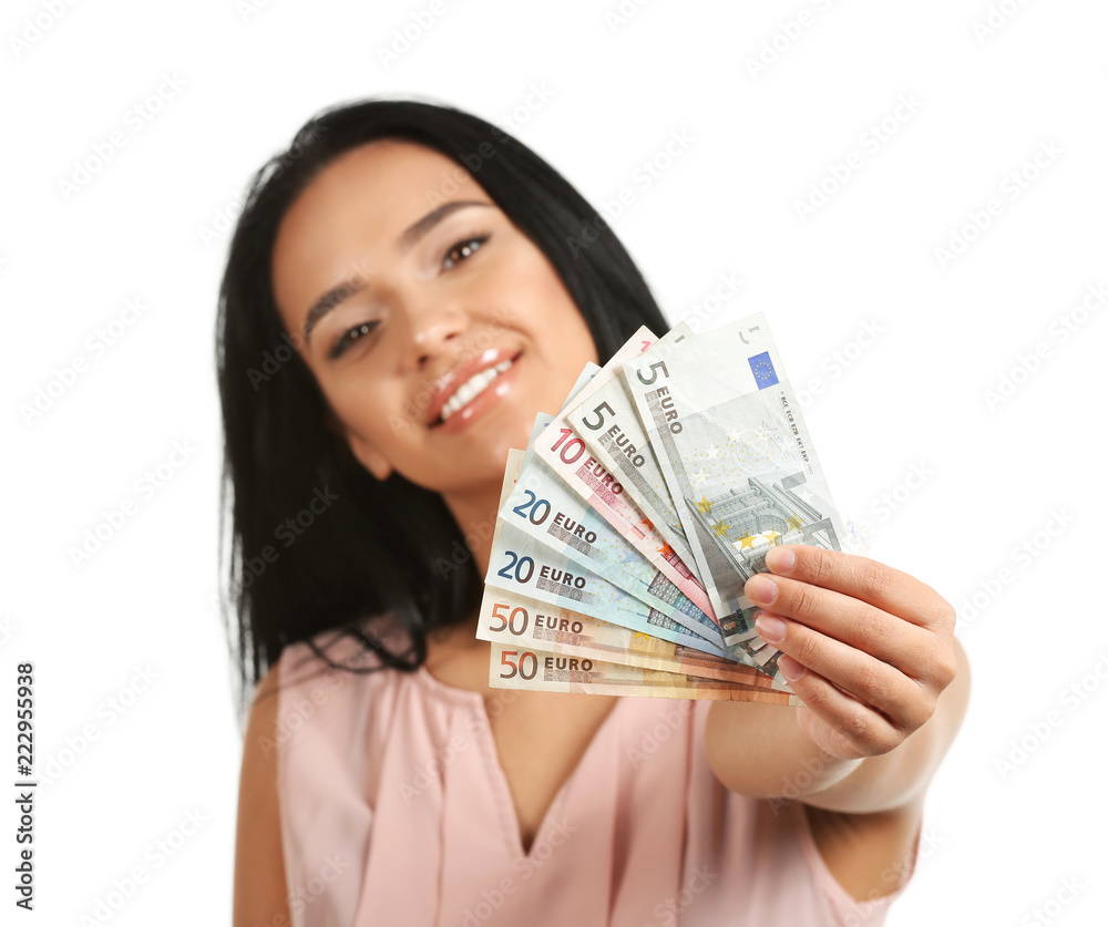 Beautiful young woman with money on white background