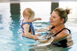 © Irina Schmidt - Happy mother swimming with cute adorable baby girl daughter in swimming pool spending spa vacations