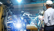 © sittinan - Production Engineer  real time monitoring system software.digital manufacturing operation. Automation robot arm machine in smart factory automotive industrial , Industry 4.0 concept