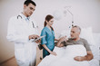 © Vadym Huzhva - Clinic and Doctor with Patient. Old Man in Hospital.