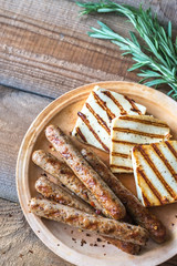 Wall Mural - Grilled sausages and cheese with rosemary