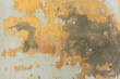 texture of old peeling yellow plaster