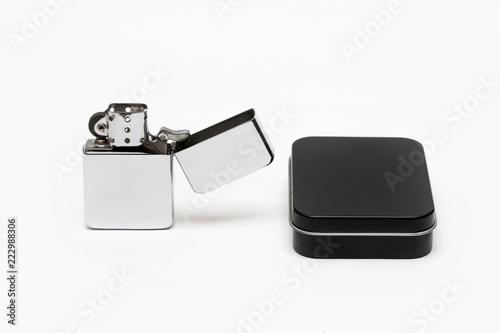 Fotomural metal cigarette lighter with a black box on a white background close-up