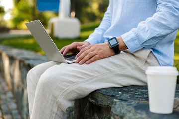 Wall Mural - Close up of a man working on laptop computer