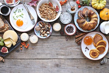 Thanksgiving Brunch. Autumn family breakfast or brunch set served on rustic wooden table. Overhead view, copy space