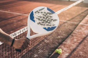 Wall Mural - Man hand grabbing a padel racket