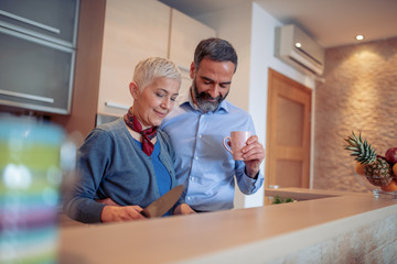 Sticker - Cheerful mature couple preparing lunch at home