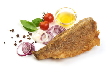 Fried fish with vegetable and oil, close-up, isolated on white background.