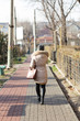 © donikz - Girl walking on the path of the sidewalk