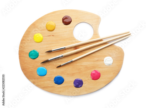 Fotografía Palette with paints and brushes on white background, top view