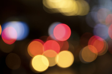 Wall Mural - Blurry background image of defocused colorful lights at night