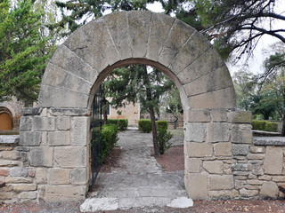 Front view of stone door with arch shaped exterior. Door open