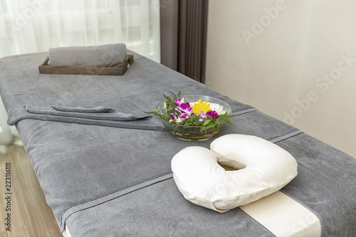 Pillow With Towel And Flower On Massage Table In Modern Spa Salon
