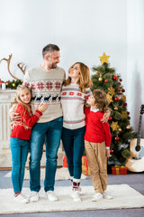 happy young family embracing on christmas at home