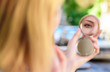 © be free - Reflexion girl looking in mirror check her appearance. Woman looking in her pocket mirror selective focus defocused background. Check if everything is right. Beauty treatment and skin care concept