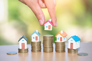 Mini house on stack of coins, Real estate investment, Save money with stack coin, Business growth investment and financial, Mortgage concept.