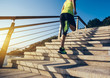 © lzf - Healthy lifestyle sports woman running up on stone stairs seaside
