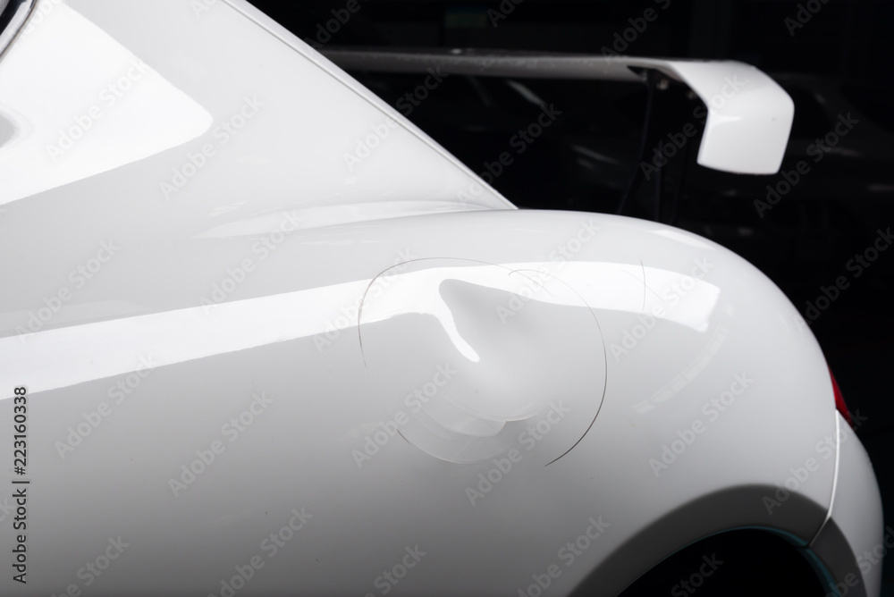 Auto body repair series: Dent on white sports car - obrazy, fototapety, plakaty 