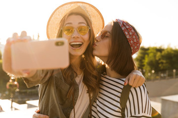 Sticker - Two positive young girls friends having fun together