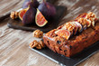 Homemade delicious fig cake with nuts on rustic wooden background