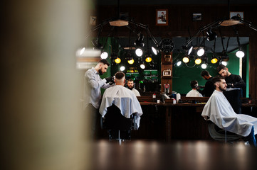 Handsome bearded man at the barbershop, barber at work.