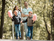 © ASDF - happy brother and sister with cotton candy on a walk in the Park.