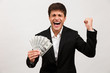 © Drobot Dean - Happy businessman standing isolated holding money make winner gesture.