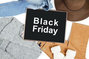 Wall Mural - Black Friday promotion banner concept. Autumn clothing essentials for fashion boutique look book showcase. Casual set of matching garment items. Background, close up, top view, flat lay.