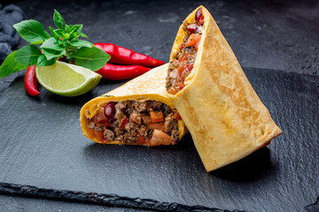 Wall Mural - Mexican burrito with meat on black