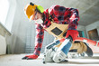© Kadmy - builder at work. cutting concrete floor for cabling by diamond slitting machine
