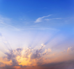 Wall Mural - sunset / sun rise sky with rays of yellow and red light shining clouds and sky background and textur