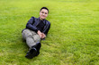Asian yong man lying on the grass