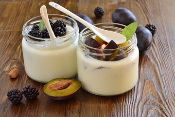 Wall Mural - Homemade yogurt in small jars with berries, fruits, almonds