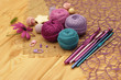 colorful yarn for knitting on a brown wooden table