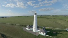 Drone Footage Filmed At Nash Point Lighthouse During A Sunset. Would Make A Great Establishing Shot