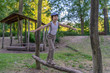 © Sergey Kohl - A boy dressed in pants with suspenders and a sleeveless shirt in the playground.