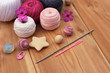 crochet pink and grey hooks and yarn, wooden background copy space