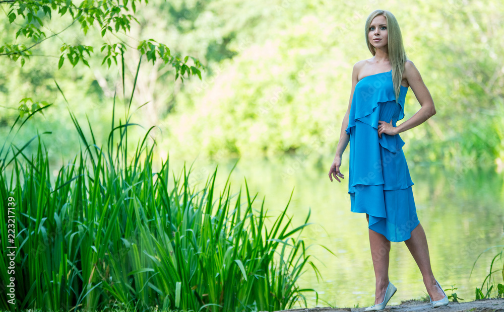 Beautiful young girl in a dress walking in the summer Park Stock Photo ...