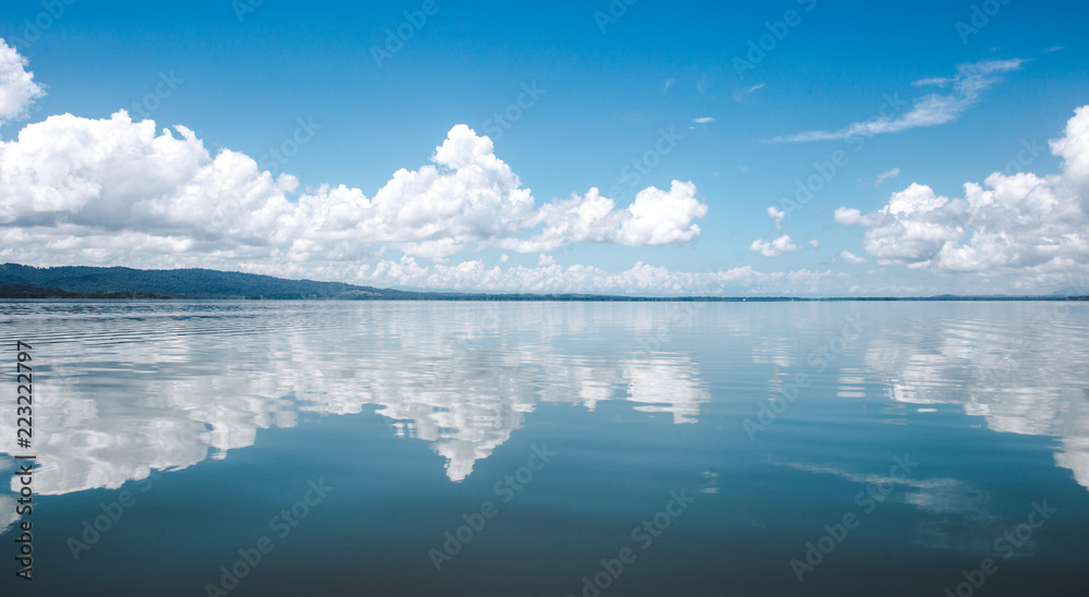 Beautiful tranquility of the calm, smooth water on the lake at El Golfete, in between Rio Dulce and Livingston in Guatemala - obrazy, fototapety, plakaty 