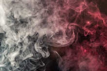 Colorful Smoke On A Black Background Of Red And White Colors. The Concept Of Smoking. Beautiful Textural Background