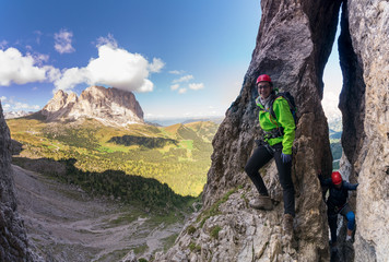 two young attracttive female mountain climber in the dolomites of italy with a great panorama view o