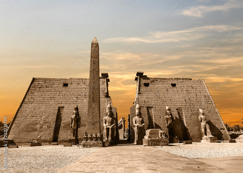 Entrance to Luxor Temple at sunset, a large Ancient Egyptian temple complex located on the east bank of the Nile River in the city today known as Luxor (Thebes). Was consecrated to the god Amon-Ra - obrazy, fototapety, plakaty 