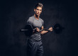 © Fxquadro - Handsome sportsman with stylish hair dressed in a sportswear doing the exercises with the barbell.
