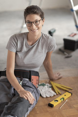 Wall Mural - Repairwoman sitting on the floor and posing