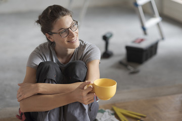 Wall Mural - Woman doing a home renovation and having a coffee break