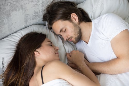 Loving Millennial Couple Sleep Together Holding Hands Young