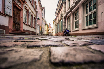 Canvas Print - Old European cobblestone street from low perspective, Heidelberg Germany